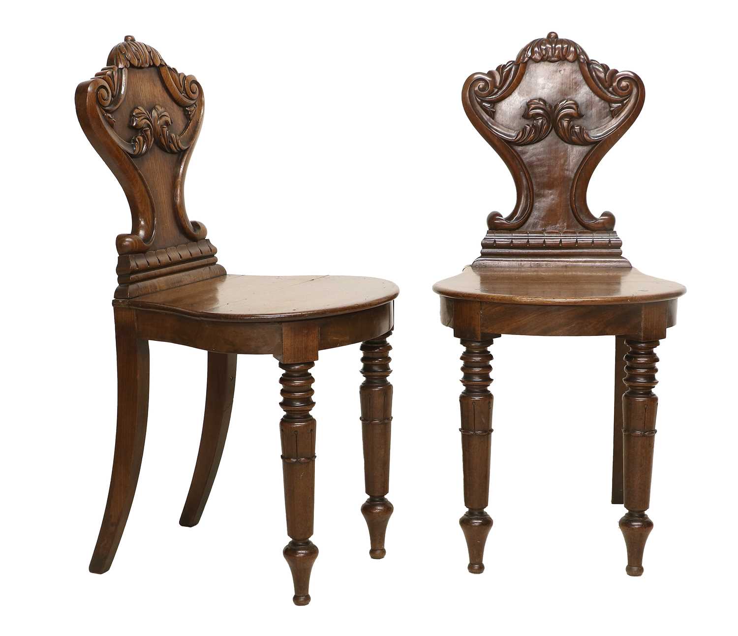 A Pair of William IV Carved Mahogany Hall Chairs, 2nd quarter 19th century, the acanthus leaf-carved