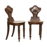 A Pair of William IV Carved Mahogany Hall Chairs, 2nd quarter 19th century, the acanthus leaf-carved