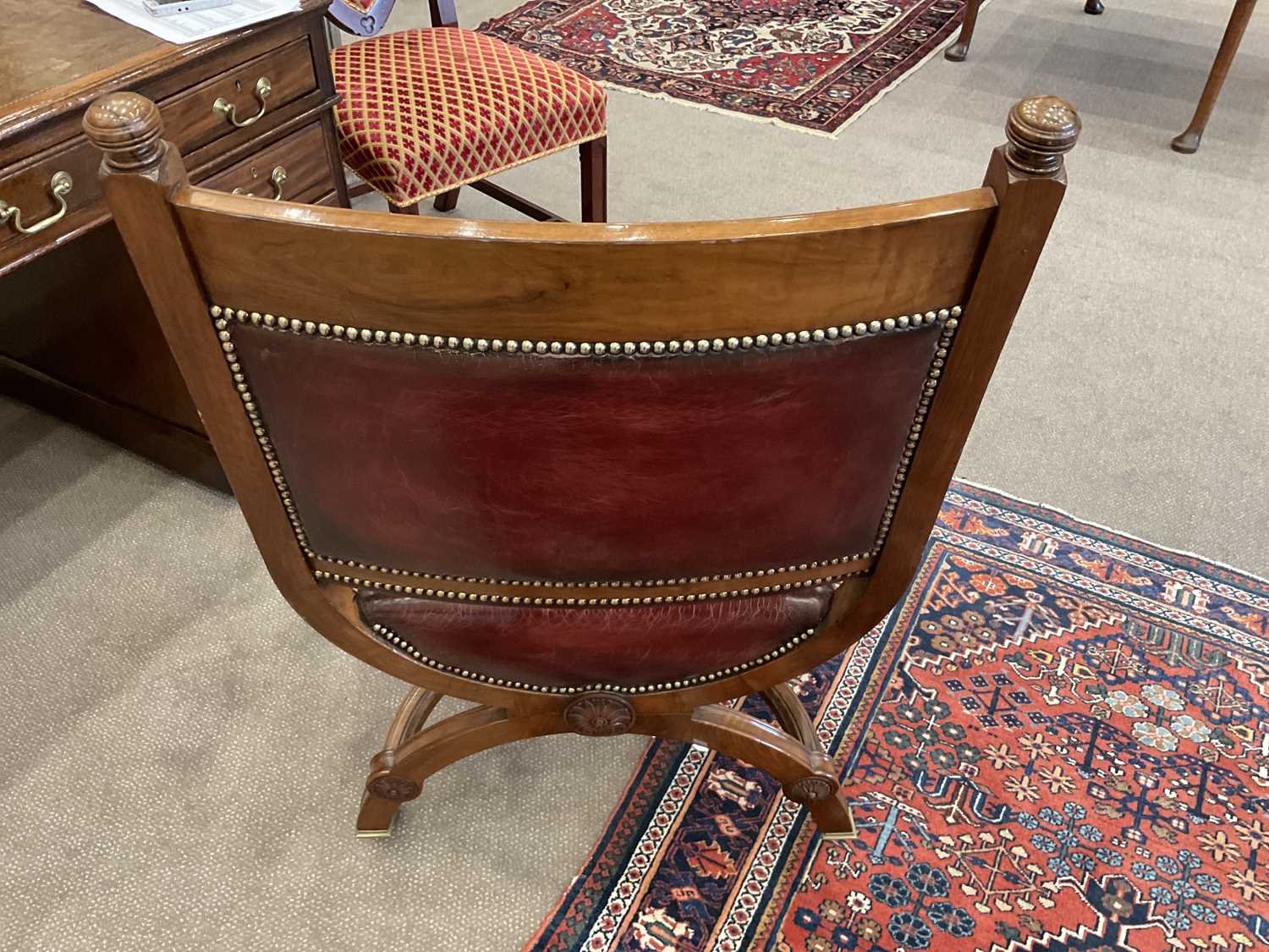 A Victorian Walnut X-Form Chair, late 19th century, recovered in red close-nailed leather, the - Image 4 of 5