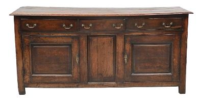 A George II Oak Enclosed Dresser Base, mid 18th century, the three plank top above three pine-