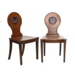 A Pair of George III Mahogany Hall Chairs, early 19th century, the circular back supports painted