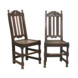 A Pair of Joined Oak Back Stools, circa 1700, the C scroll carved top rails above fluted uprights,