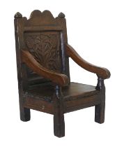 An Early 18th Century Joined Oak Child's Open Armchair, the scrolled top rail with moulded finials