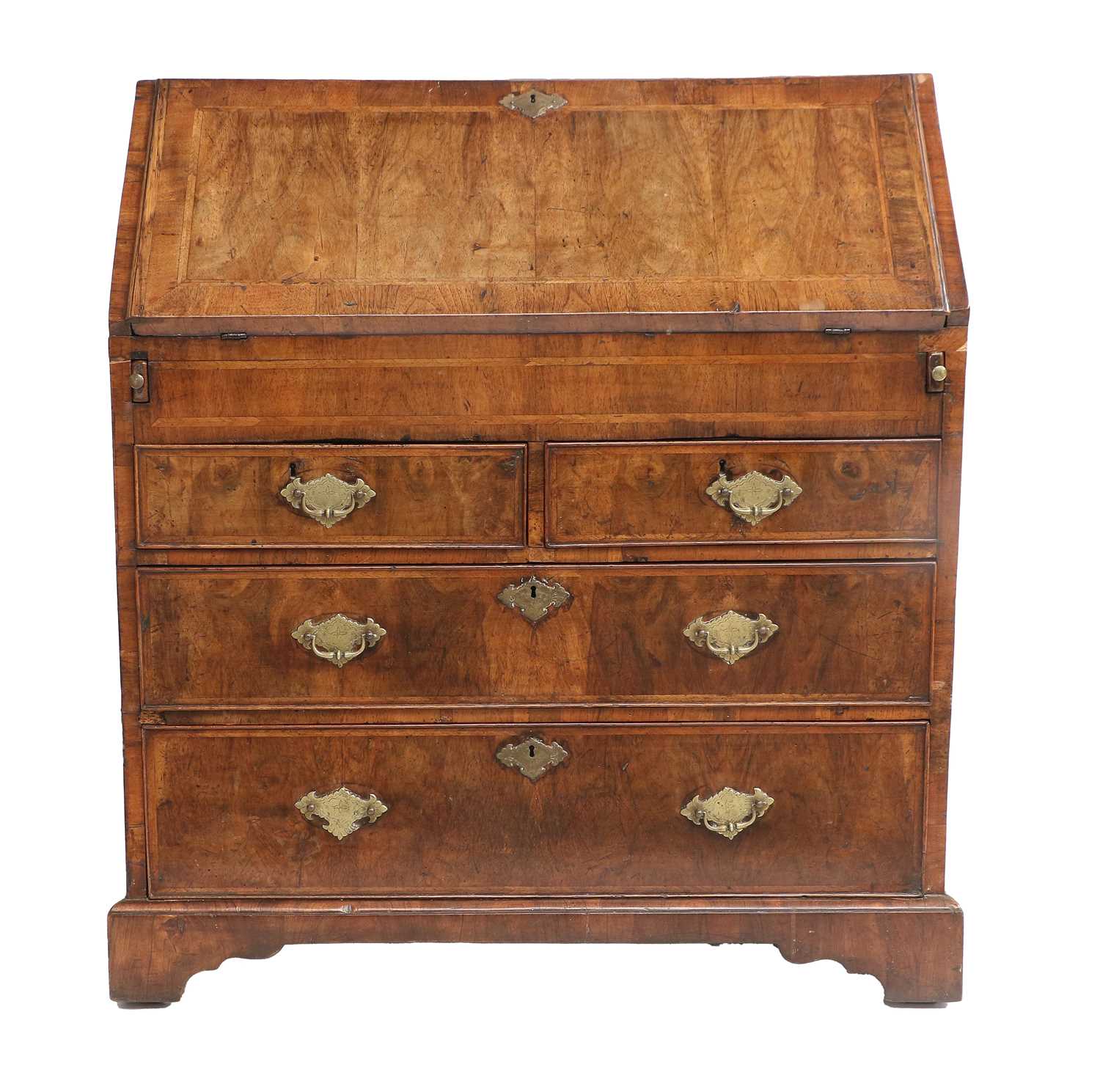 A Queen Anne Walnut and Featherbanded Bureau, early 18th century, the crossbanded fall front