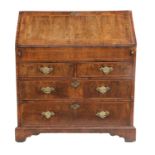 A Queen Anne Walnut and Featherbanded Bureau, early 18th century, the crossbanded fall front