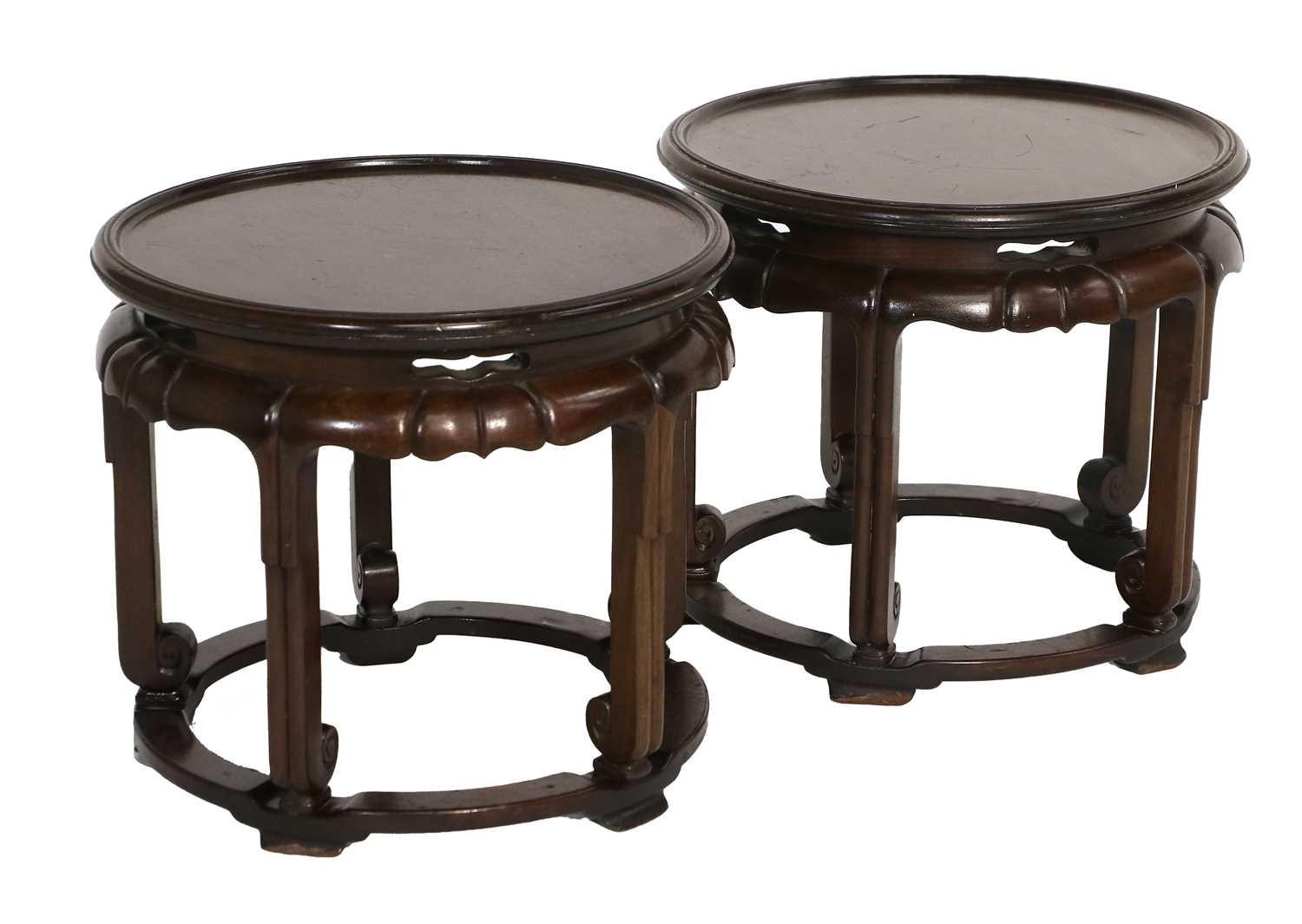 A Pair of Early 20th Century Chinese Circular Hardwood Plant Stands, the moulded dished tops above