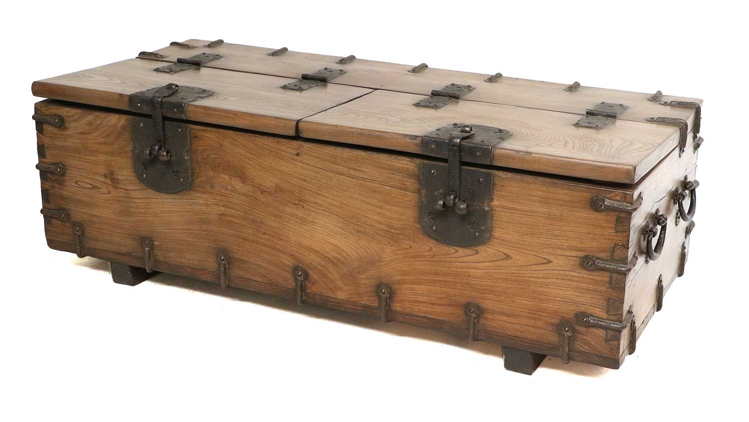 A Japanese Hardwood and Iron-Bound Trunk, modern, used as a coffee table with later glass top, the