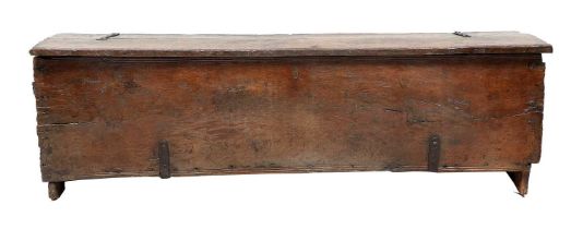 A Late 16th Century Boarded Oak Chest, of six plank construction, the hinged lid with moulded edge