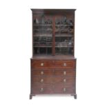 A George III Mahogany, Tulipwood-Banded and Boxwood-Strung Secretaire Bookcase, circa 1820, the