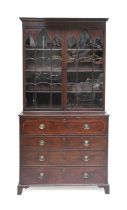 A George III Mahogany, Tulipwood-Banded and Boxwood-Strung Secretaire Bookcase, circa 1820, the