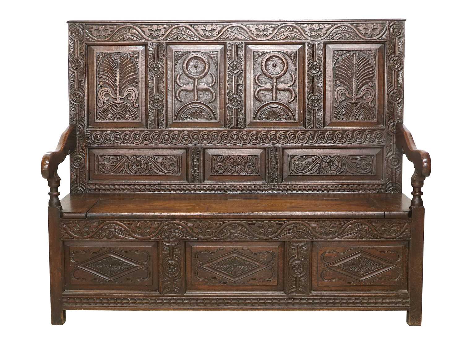 An 18th Century Carved Oak Box Settle, the back support with four panels carved in relief with