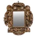 An 18th Century Italian Carved Giltwood Frame, the later plain mirror plate within acanthus leaf and