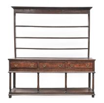 A George III Oak Dresser and Rack, 3rd quarter 18th century, the moulded cornice above iron cup