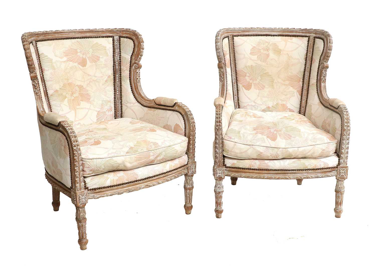 A Pair of 20th Century Upholstered Close-Nailed Armchairs, with limed wood show frames, covered in