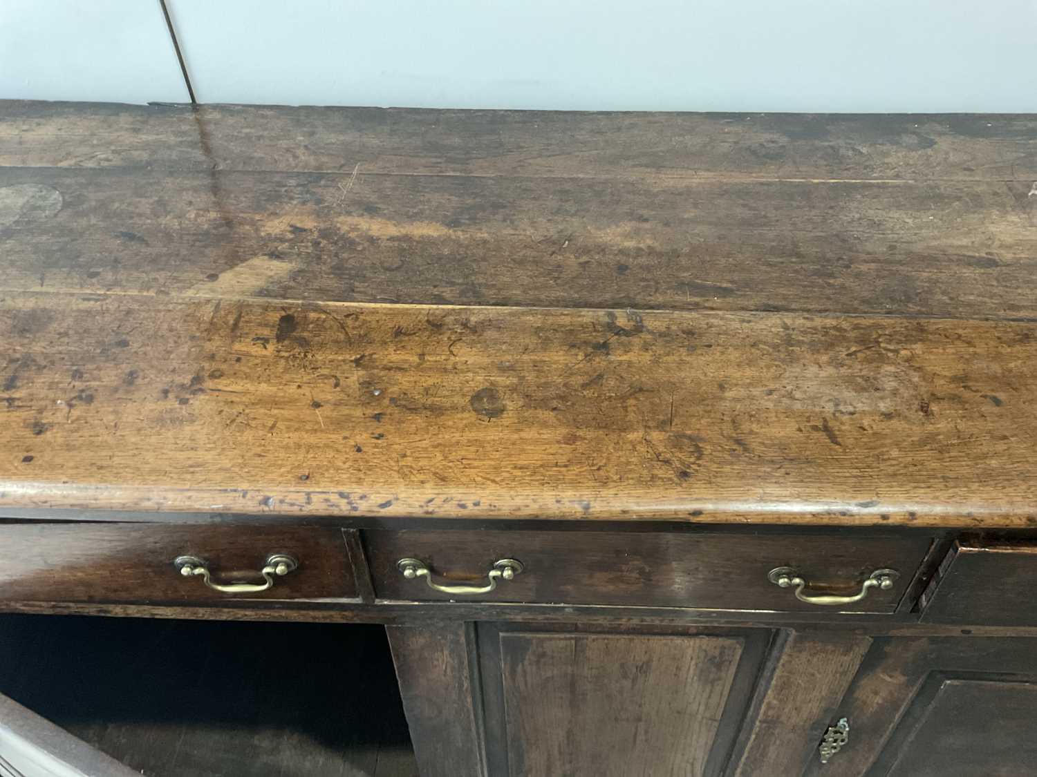 A George II Oak Enclosed Dresser Base, mid 18th century, the three plank top above three pine- - Image 6 of 9