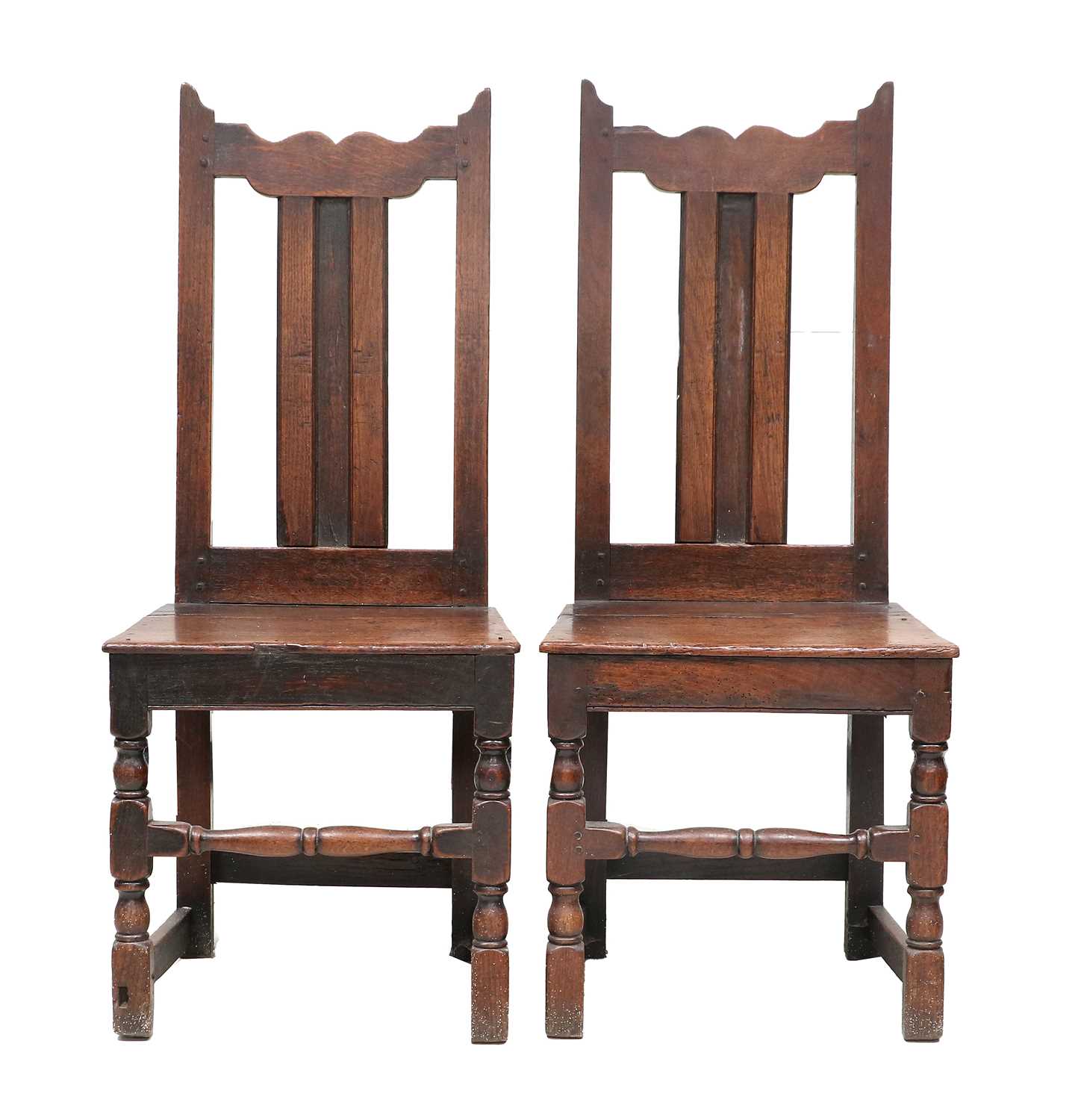 A Pair of Joined Oak Back Stool, circa 1720, the wavy-shaped top rails above moulded splats and