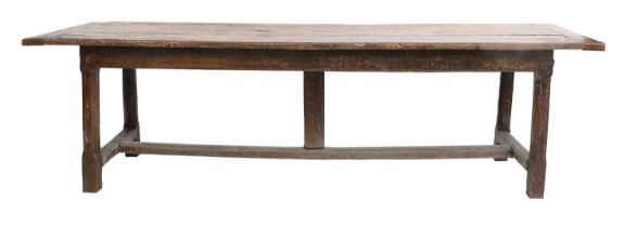 An Early 18th Century Rustic Oak Dining Table, the rectangular top of three-plank construction
