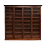 A Victorian Mahogany Bookcase, the moulded cornice above four conforming glazed doors enclosing