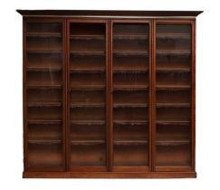 A Victorian Mahogany Bookcase, the moulded cornice above four conforming glazed doors enclosing