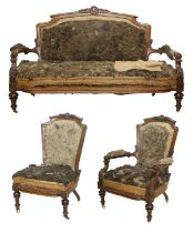 A Victorian Carved Walnut-Framed Three-Piece Suite, circa 1870, comprising: a two-seater sofa with
