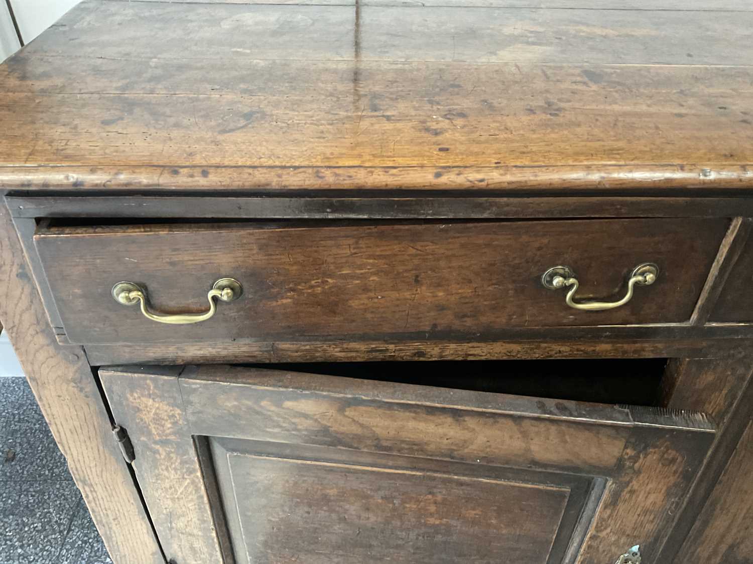 A George II Oak Enclosed Dresser Base, mid 18th century, the three plank top above three pine- - Image 7 of 9