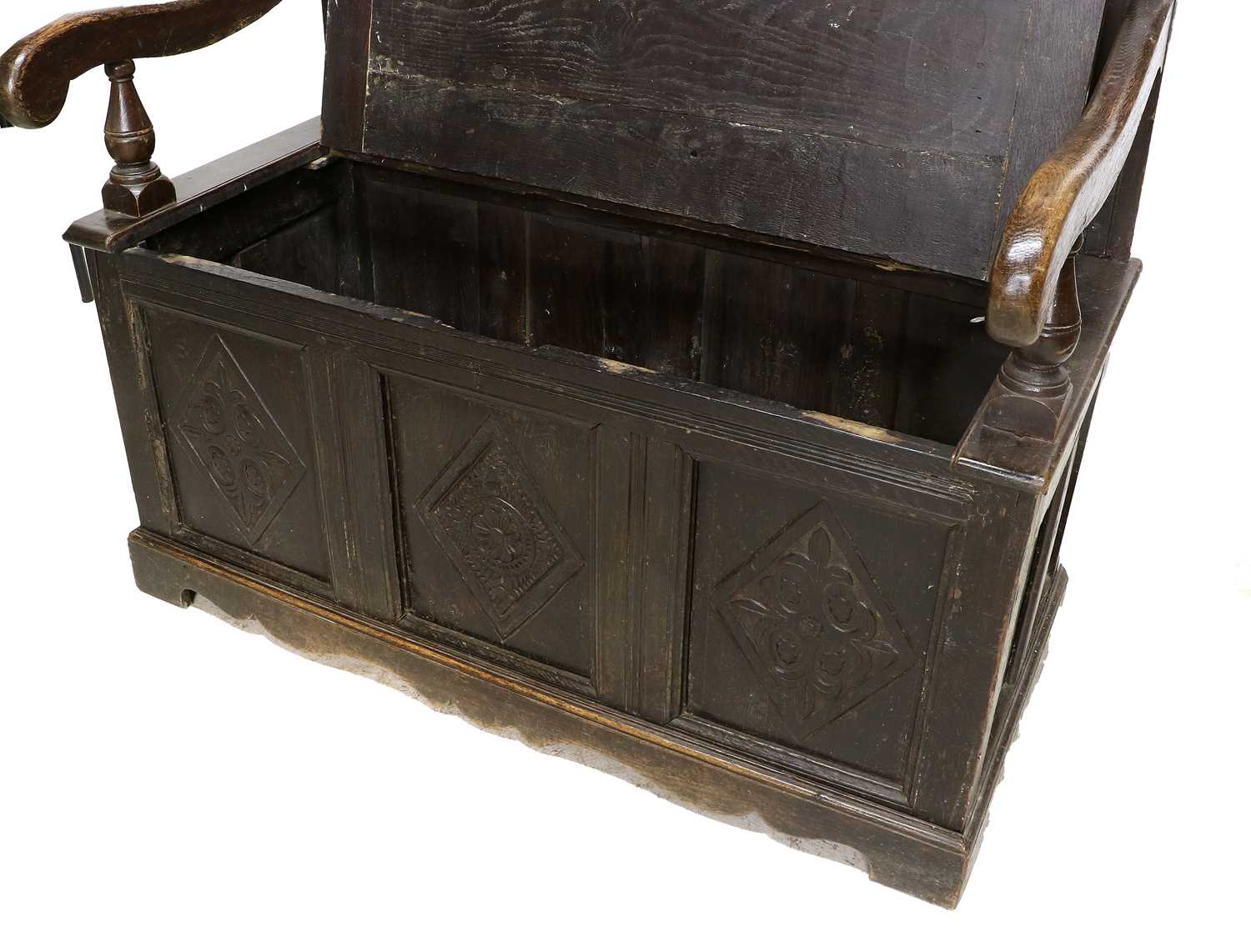 A Carved Oak Settle, the associated back support with nine panels carved with lozenges and scrolls - Image 2 of 3