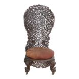 A Late 19th Century Anglo-Indian Bombay Slipper Shaped Chair, with foliate carved back support and