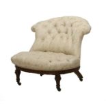 Holland & Sons: A Victorian Carved Walnut Nursing Chair, late 19th century, recovered in cream,