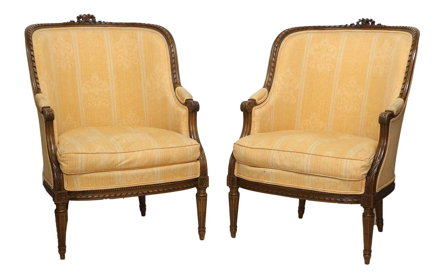 A Pair of Early 20th Century Carved Walnut or Beech Framed Tub Armchairs, recovered in orange floral