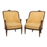 A Pair of Early 20th Century Carved Walnut or Beech Framed Tub Armchairs, recovered in orange floral