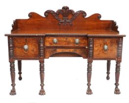 An Irish Regency Carved Mahogany Sideboard, early 19th century, with three-quarter scrolled and
