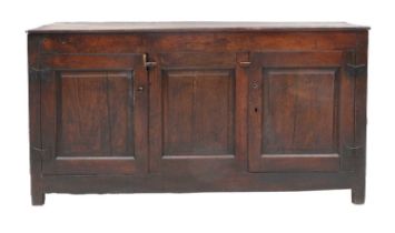 A Mid 18th Century Oak Enclosed Dresser Base, the boarded top above two fielded cupboard doors