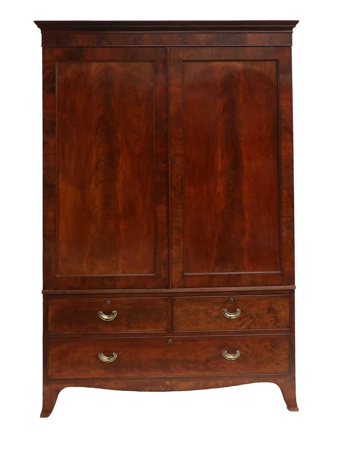 A George III Mahogany Linen Press, early 19th century, the moulded cornice above a plain frieze