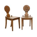 A Pair of Victorian Carved Oak Hall Chairs, dated 1843, the circular carved back supports with a