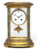 A French Oval Shaped Brass and Champleve Enamel Striking Mantel Clock, circa 1900, oval shaped