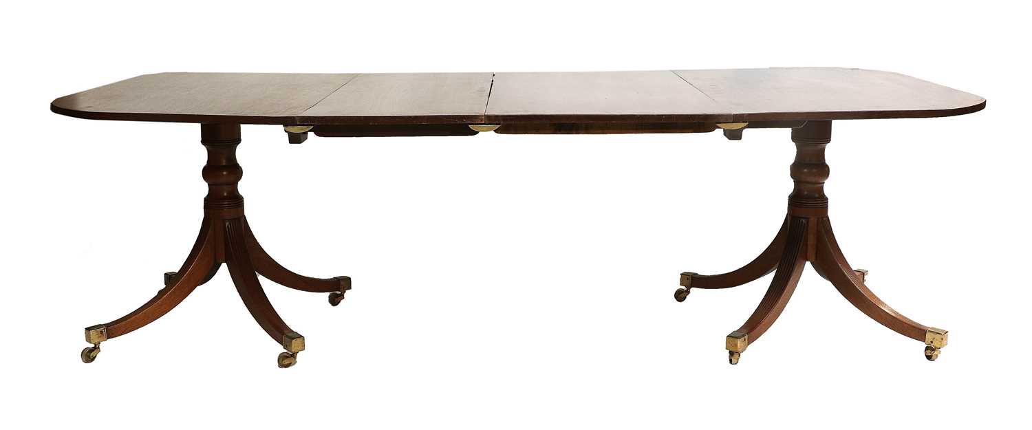 A Late George III Mahogany Twin-Pedestal Dining Table, early 19th century, with two additional