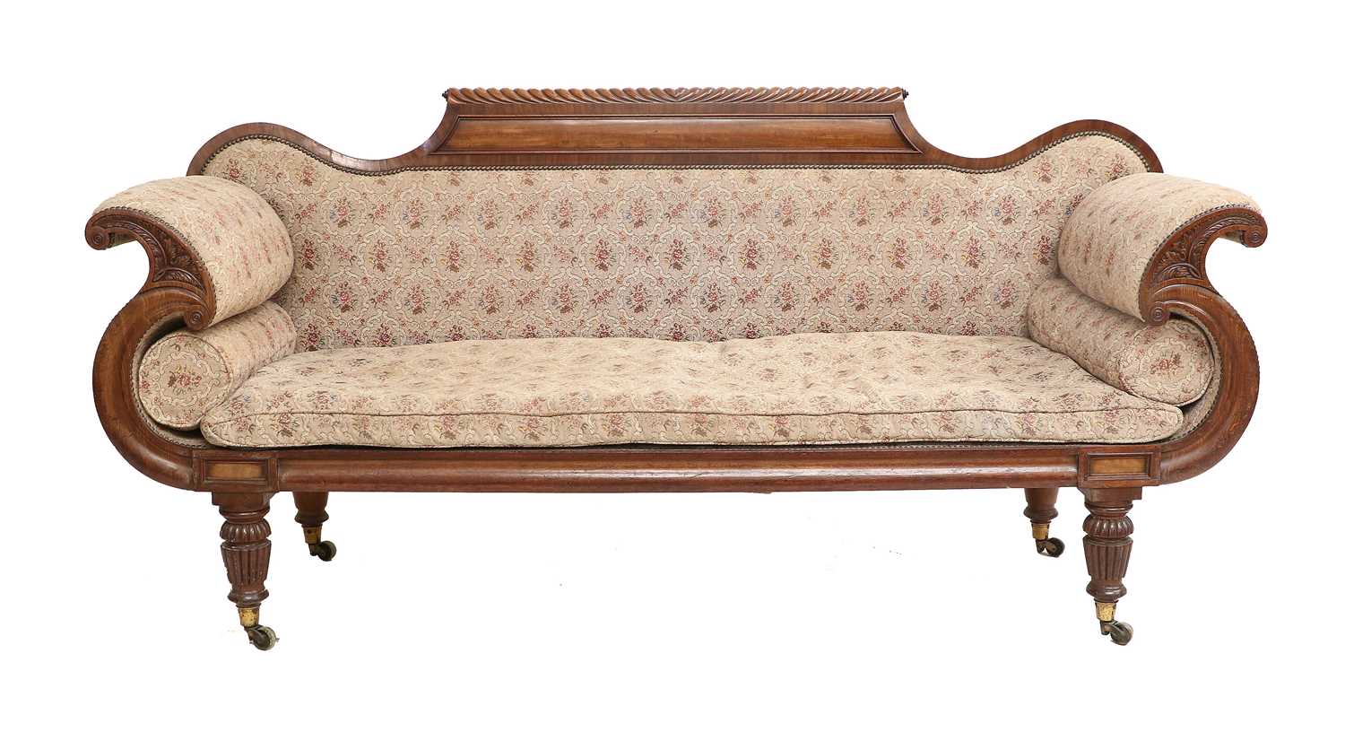 A Regency Carved Mahogany Scroll-End Sofa, early 19th century, covered in close-nailed floral