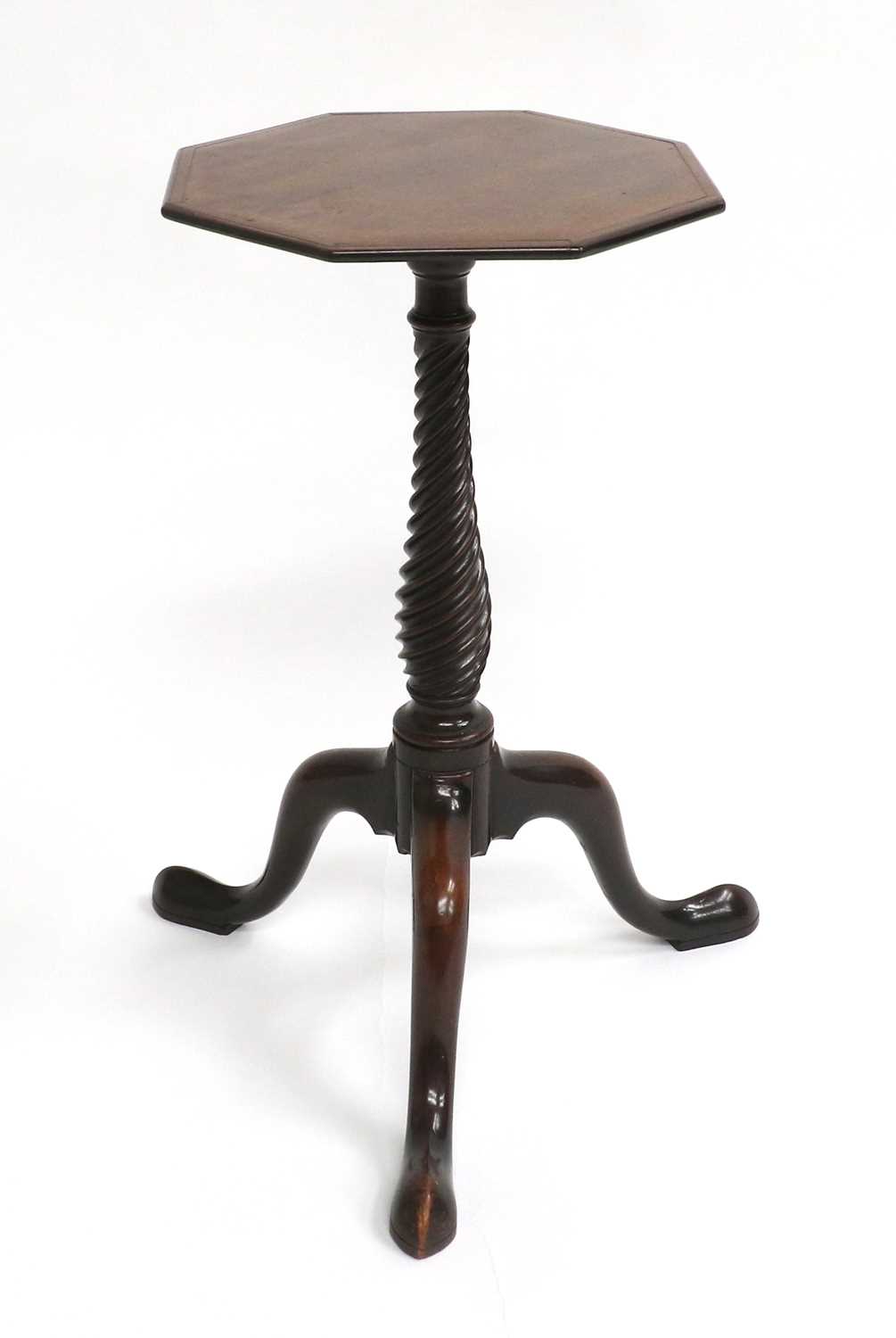 A George III Mahogany Octagonal Wine Table, late 18th century, the crossbanded top on a spiral