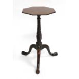 A George III Mahogany Octagonal Wine Table, late 18th century, the crossbanded top on a spiral