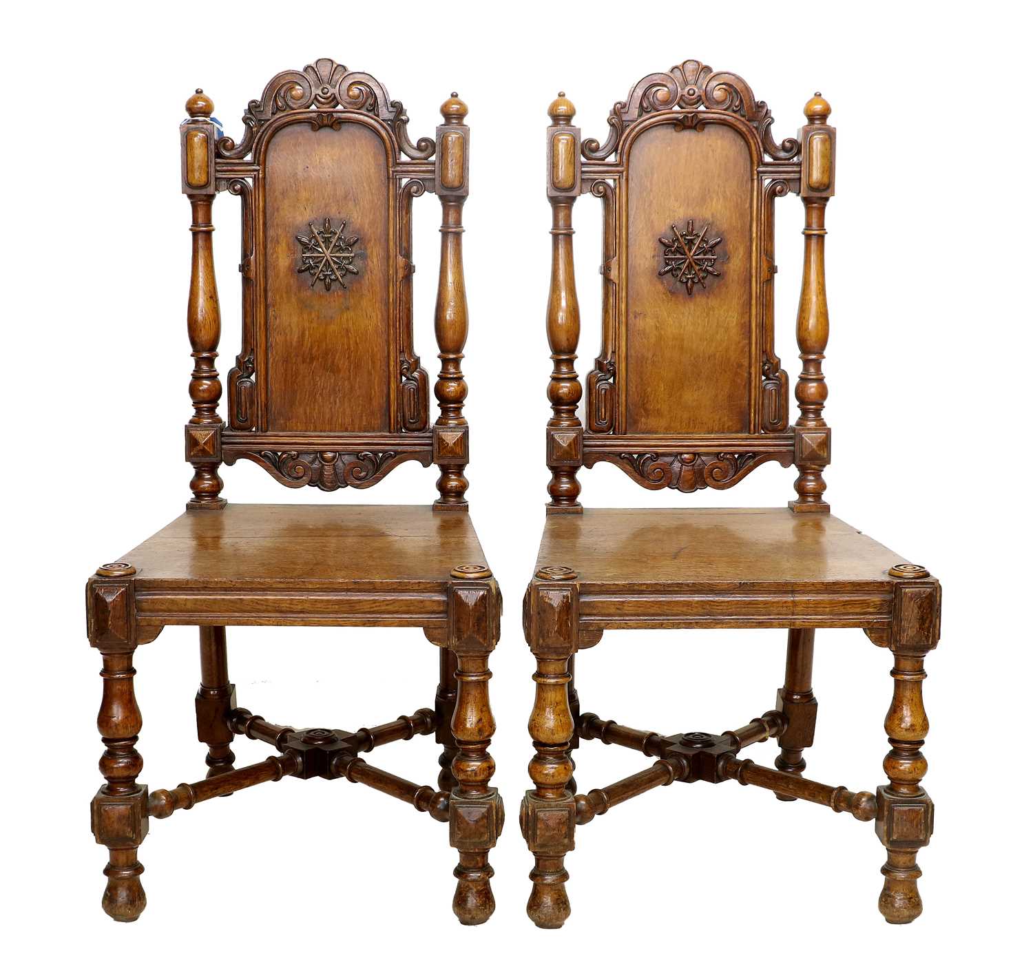 A Pair of Carved Oak Hall Chairs, by Gillows of Lancaster, mid 19th century, the carved top rails