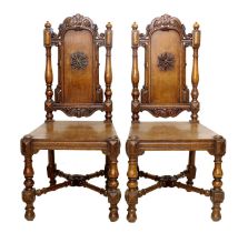 A Pair of Carved Oak Hall Chairs, by Gillows of Lancaster, mid 19th century, the carved top rails