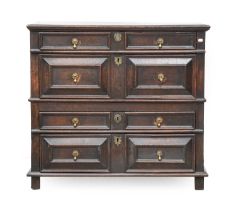 An Oak Geometric-Moulded Chest of Drawers, circa 1700, the moulded top above four two-as-one moulded