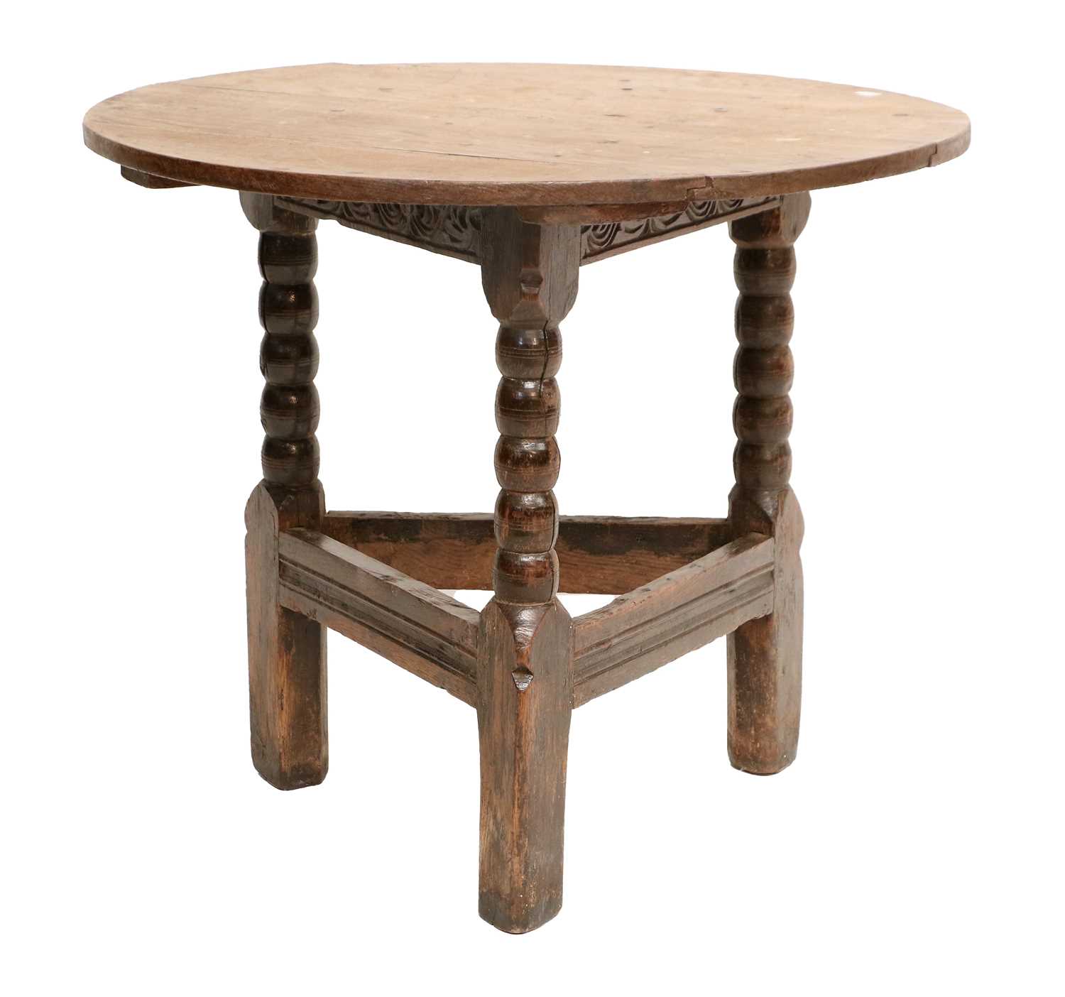 A Circular Oak Cricket Table, late 17th/early 18th century, of plank-top construction with carved