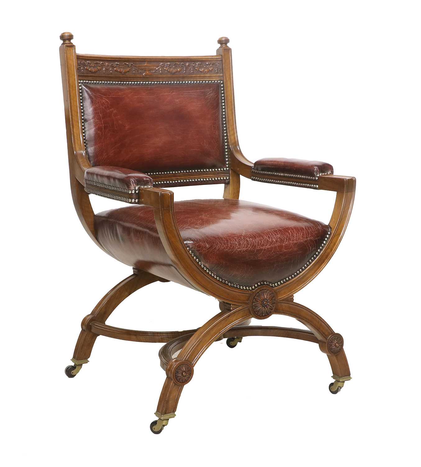 A Victorian Walnut X-Form Chair, late 19th century, recovered in red close-nailed leather, the