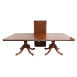 An Irish Regency Mahogany Twin-Pedestal Dining Table, early 19th century, with one additional