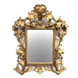A 19th Century Florentine Carved Giltwood Wall Mirror, the original mercury plain mirror plate