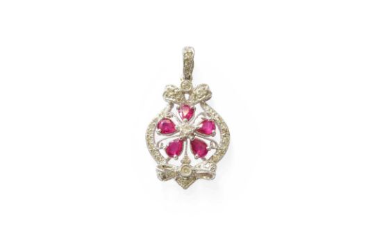 A Ruby and Diamond Pendant, of foliate and bow motif form, set throughout with pear cut rubies and