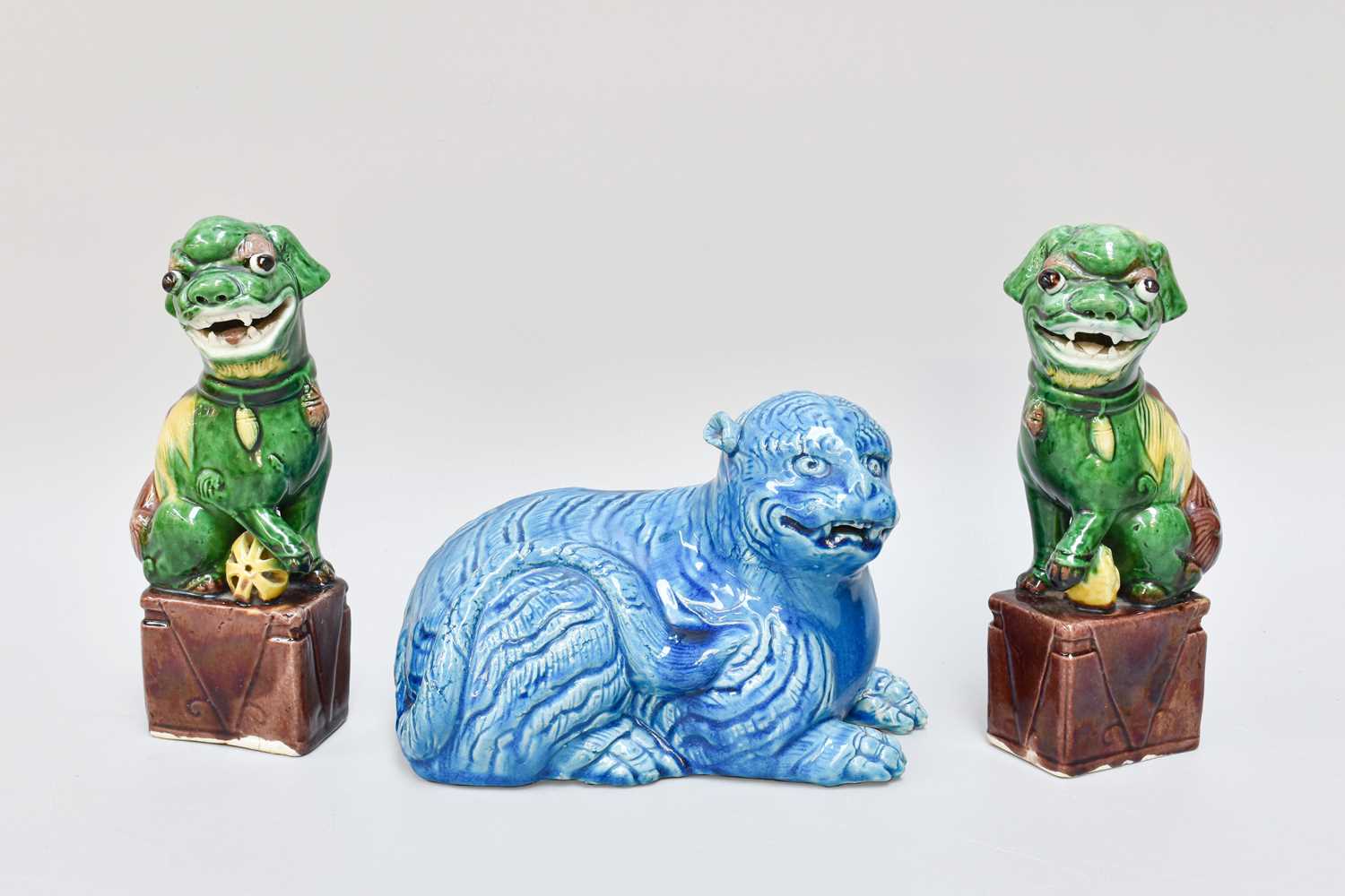 A Pair of Small Chinese Porcelain Models of Temple Lions, circa 1900, decorated in coloured