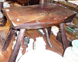 19th/20th c. heavy rustic carved elm stool with four splayed peg legs