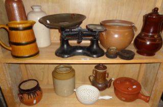 Two shelves of kitchenalia, stoneware pots, scales, etc.